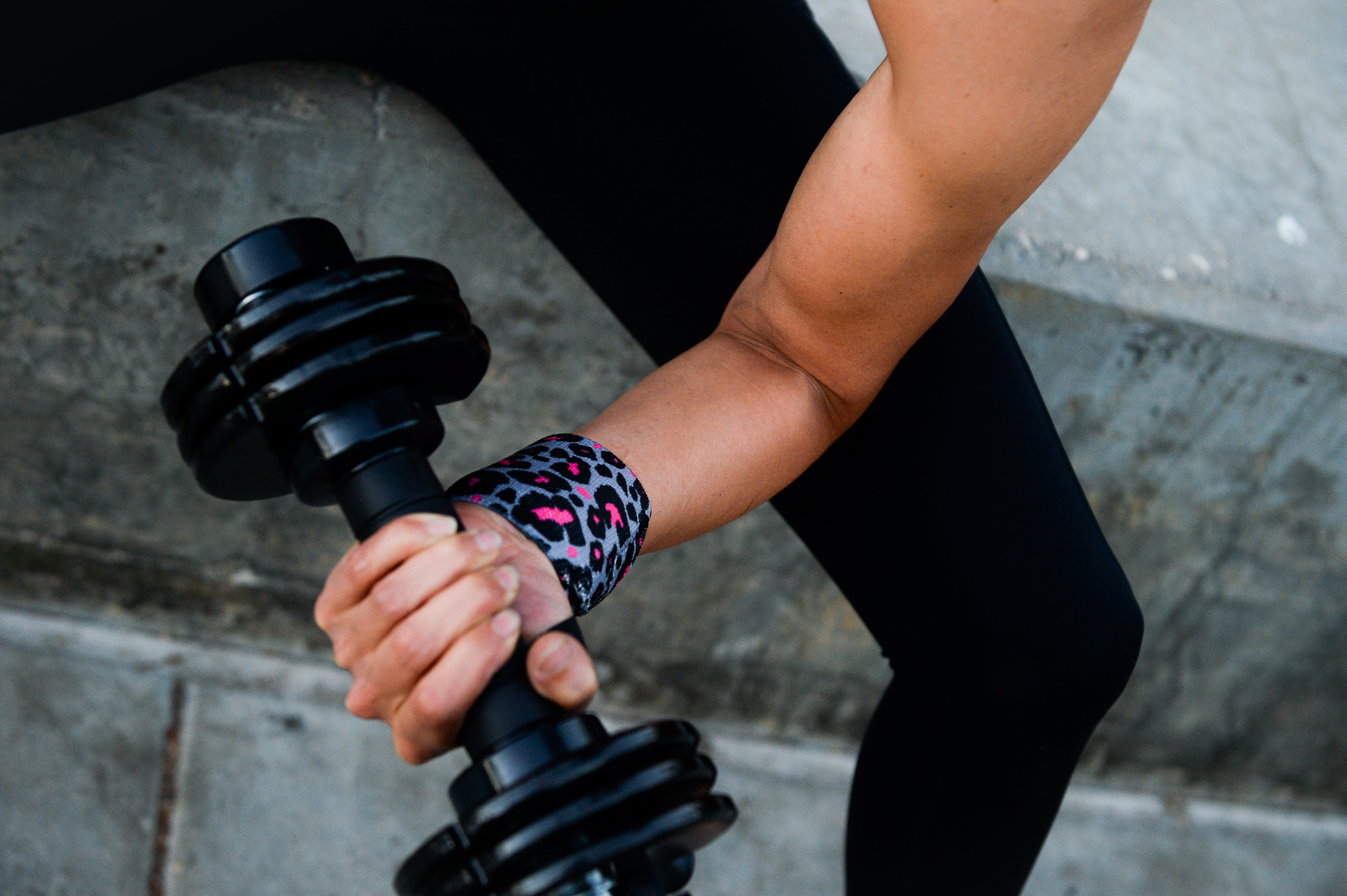 woman bicep curl rock star leopard wrist wrap
